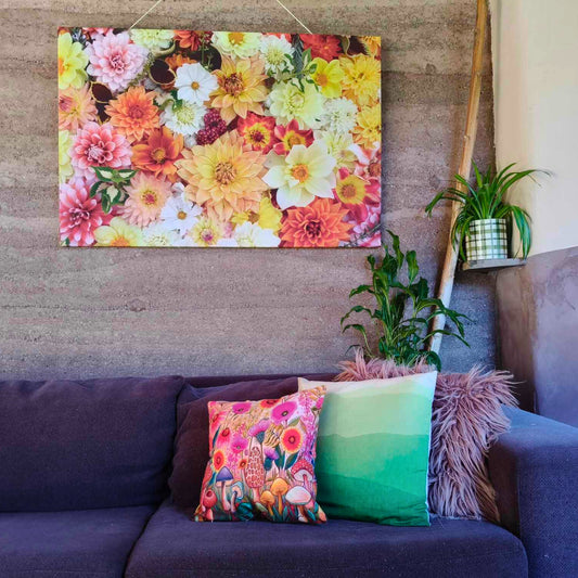 A large colourful canvas with a flatlay full of orange themed dahlias bred and photographed by Gracie-Mae Photography.